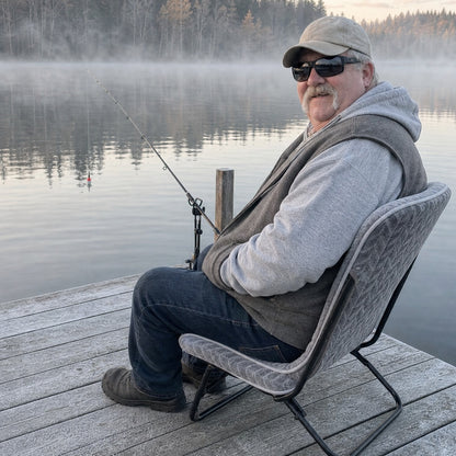 Angler fishing from a frosty dock on the WarmCast heated seat pad