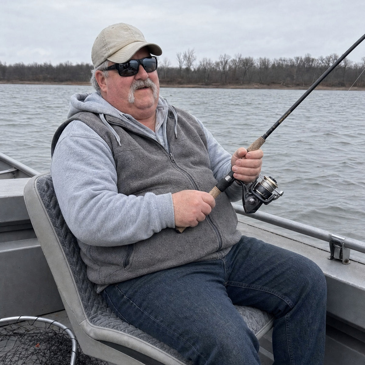 Angler in a fishing boat sitting on the WarmCast heated seat pad