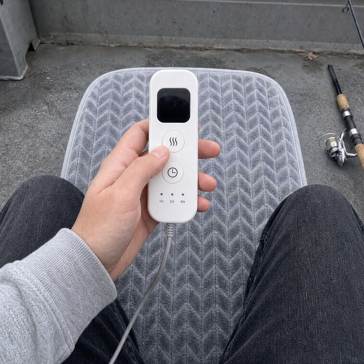 WarmCast remote and heated pad on a boat seat
